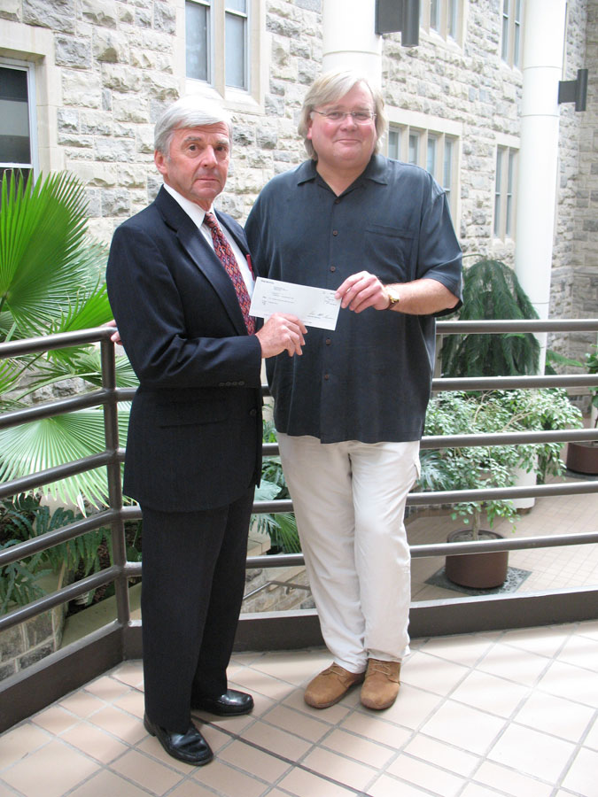 Doug Curling (right), president and chief operating officer of ChoicePoint and an alumnus of the Pamplin College of Business, presented the check to Richard E. Sorensen, dean of the Pamplin College.