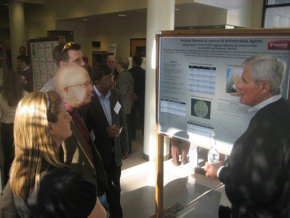 Danielle Rhine, Jonathan Leder, Michael Frodyma, and Sam Gnanamanickam, all from Novozymes Biologicals Inc. of Salem, Va., and Joe Falkinham, professor of biological sciences at Virginia Tech, discuss the poster presented by Falkinham and his students at the previous Southwest Virginia Science Forum in March. The next Forum is Dec. 10, also at the Fralin Center at Virginia Tech.