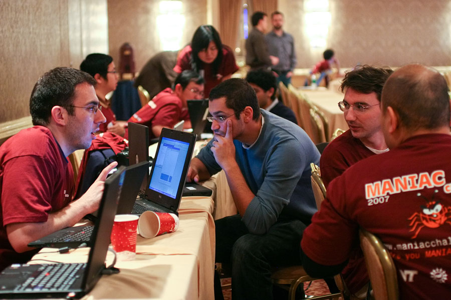 Student teams from seven universities gathered for the first MANIAC Challenge in December 2007. After the first day practice trials, the teams refined their strategies and implementations. In the foreground, the team from The George Washington University discusses the next step.
