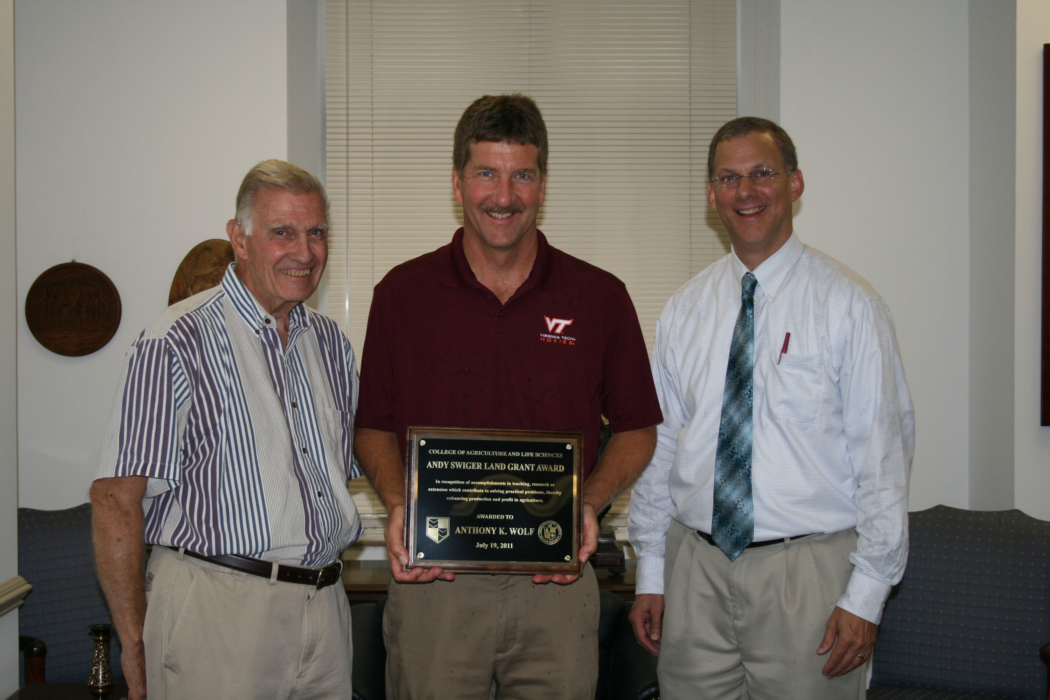 Tony Wolf (center), professor of horticulture and director of the Alson H. Smith Jr. AREC, receives the 2011 Swiger Land-Grant Award from Dean Emeritus Andy Swiger, (left) and Alan Grant, dean.