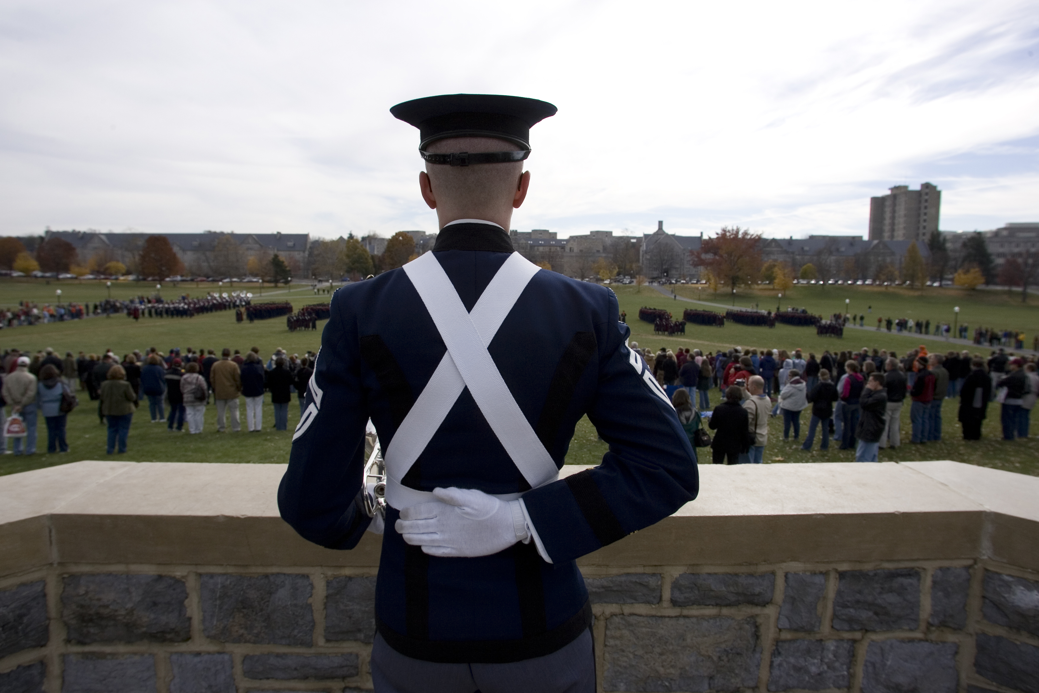 A cadet watches marching formations from the War Memorial 