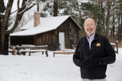 Stan Temple standing outside the Leopold Shack in Wisconsin.