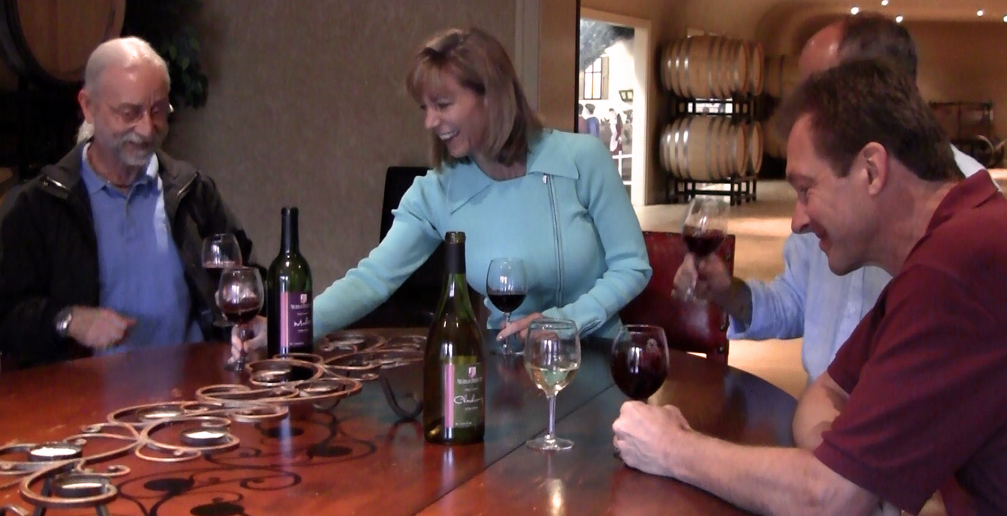 A seated group of people tasting wines. 