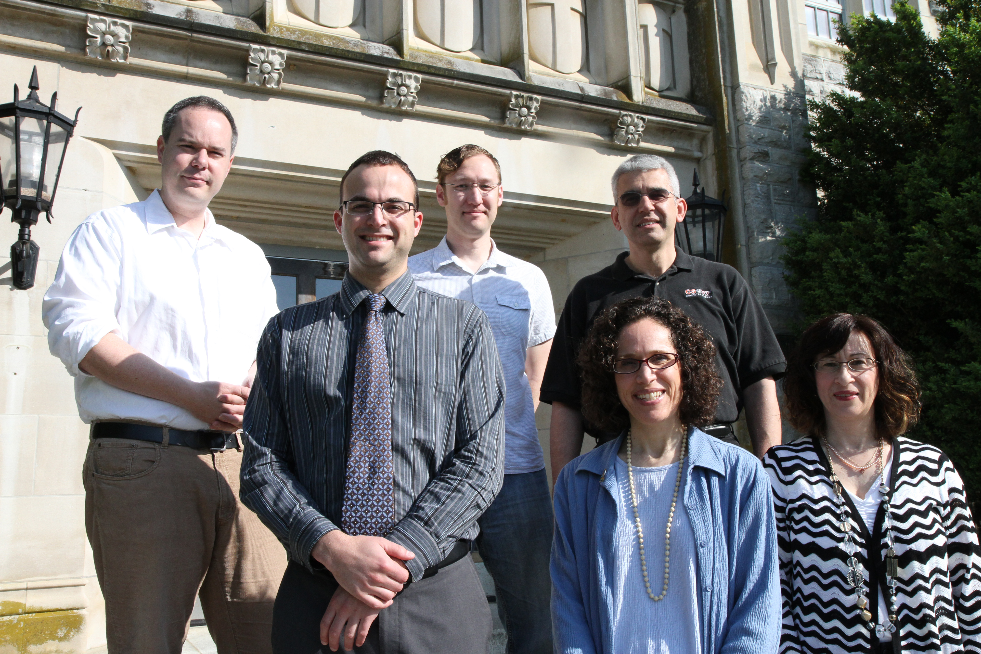 Members of the Summer Scholars In-Residence group, standing on the steps of Williams Hall.