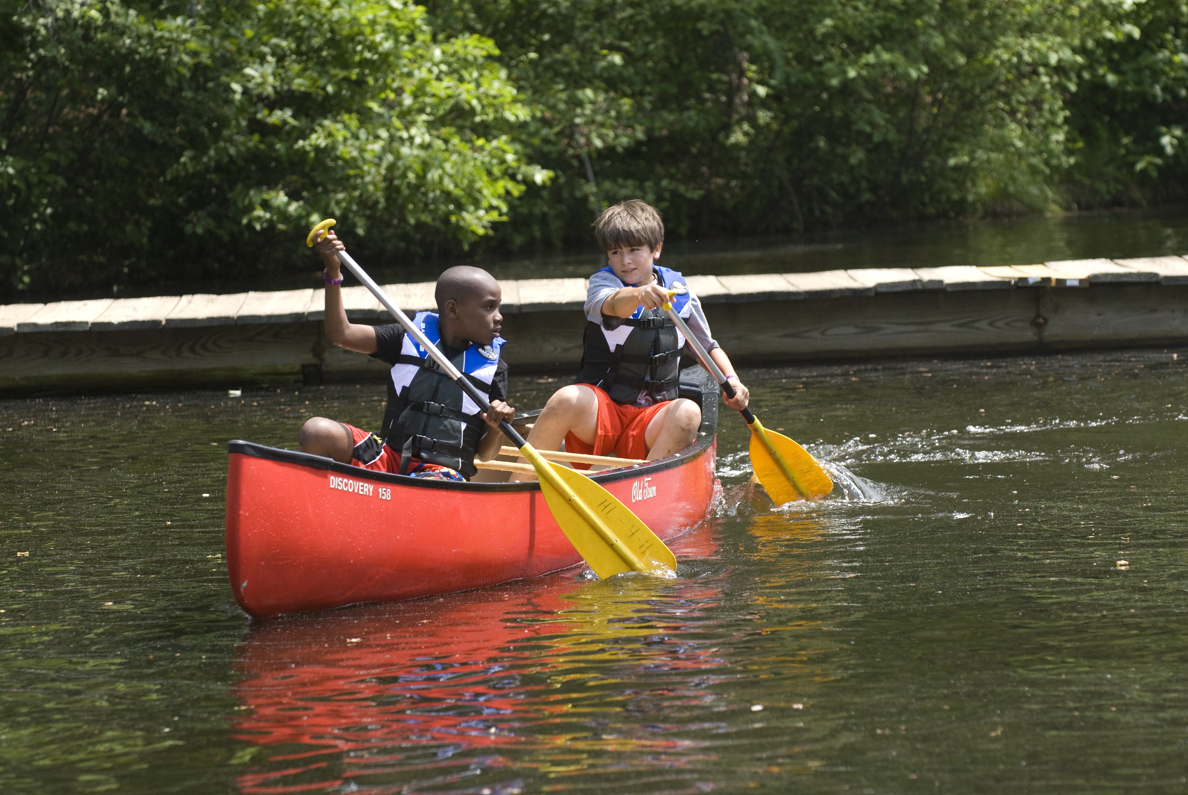 Two kids in a canoe.