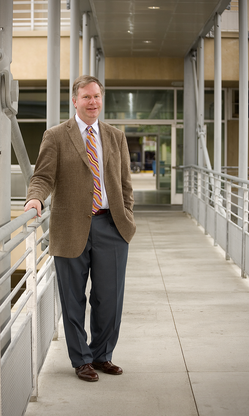 Henri deHahn stands on a covered walkway.