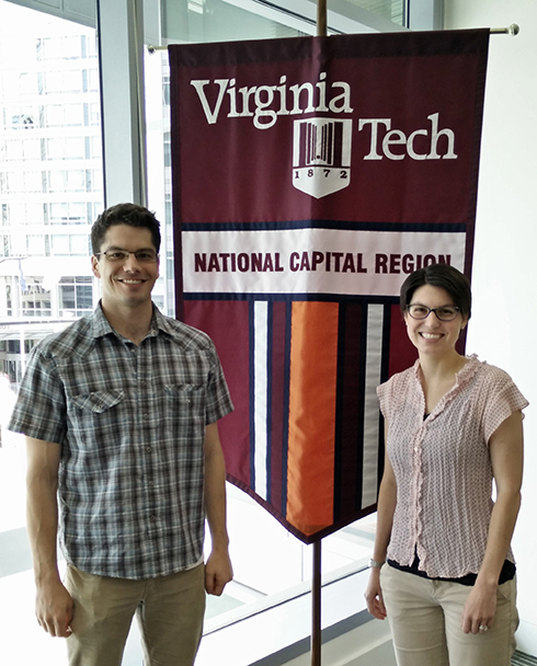 Will Walters and Katherine Royston standing in front of National Capital Region banner