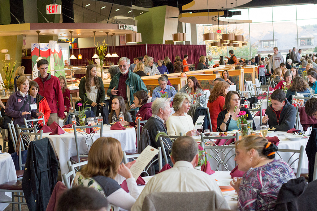 Families gather at tables to eat food in D2 during Fall Family Weekend