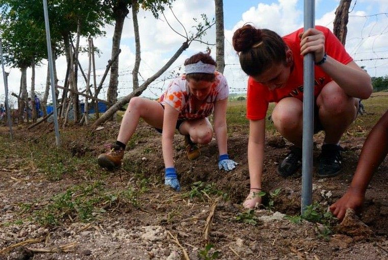 Selz and teammate dig trenches in the Dominican Republic