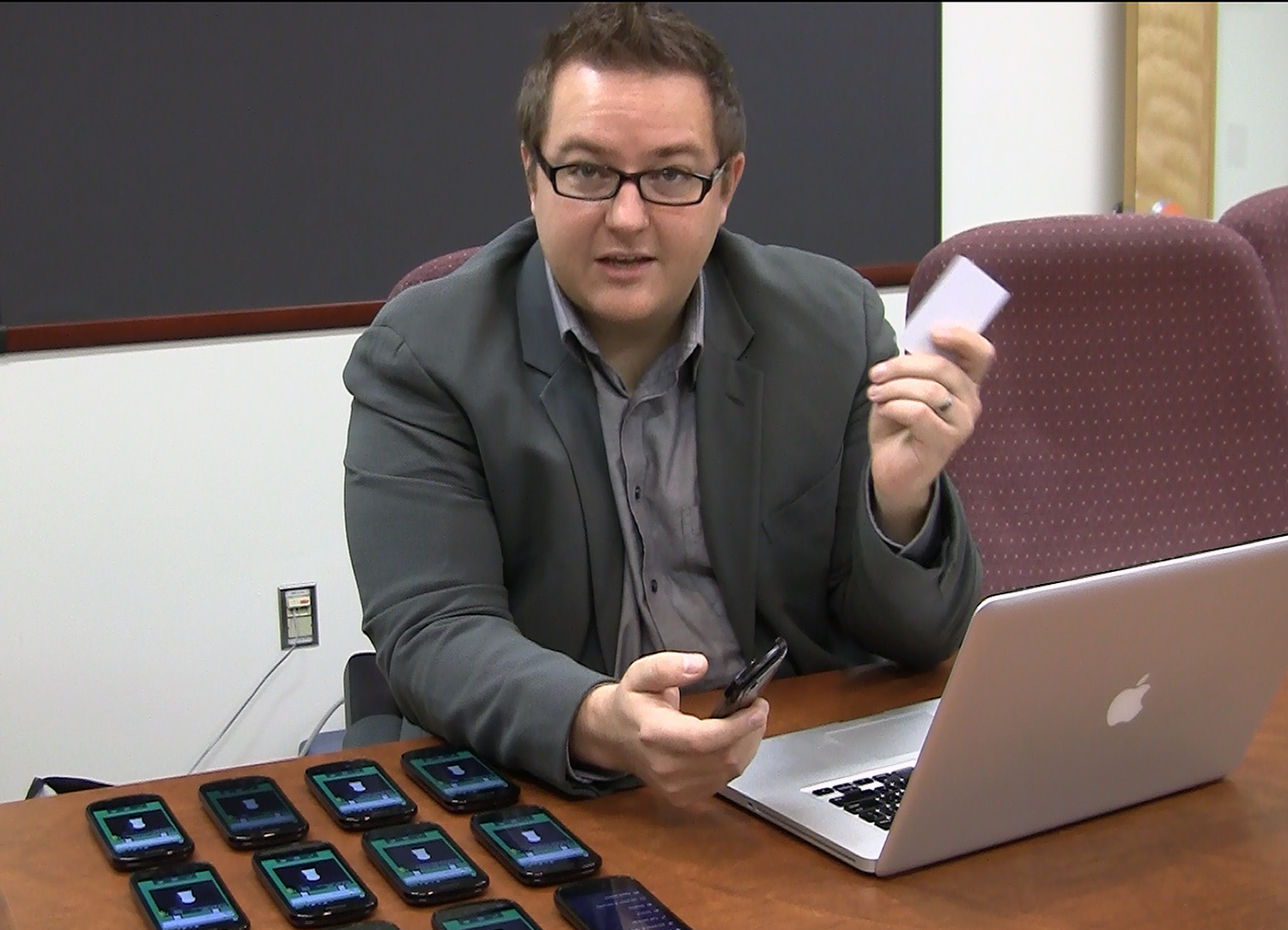 Jules White with laptop that controls the bank of cell phones