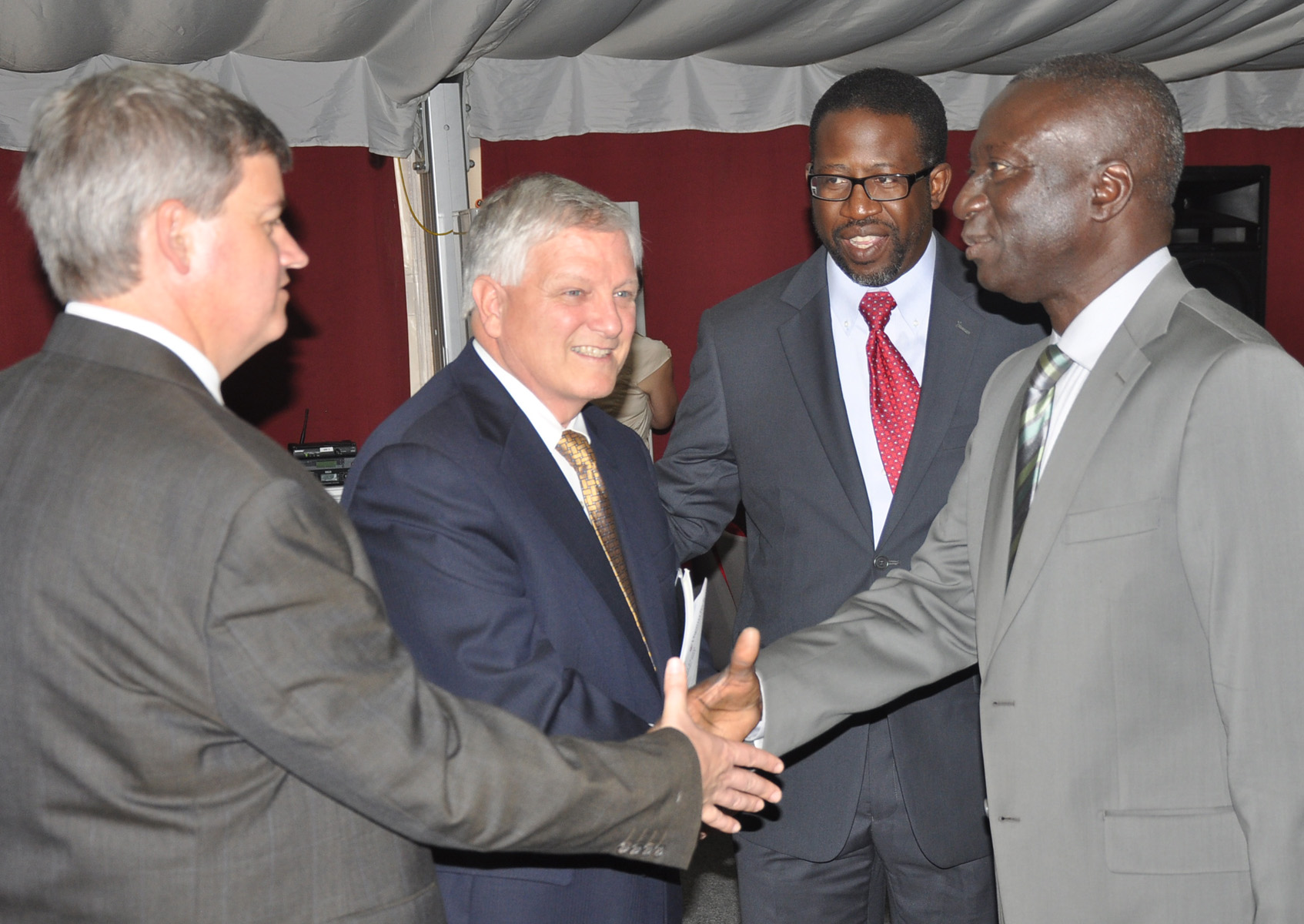 Virginia Tech official shakes hands with manager general of higher education in Senegal