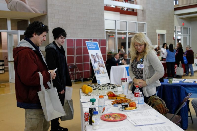 People visit a booth at a recent wellness fair. 